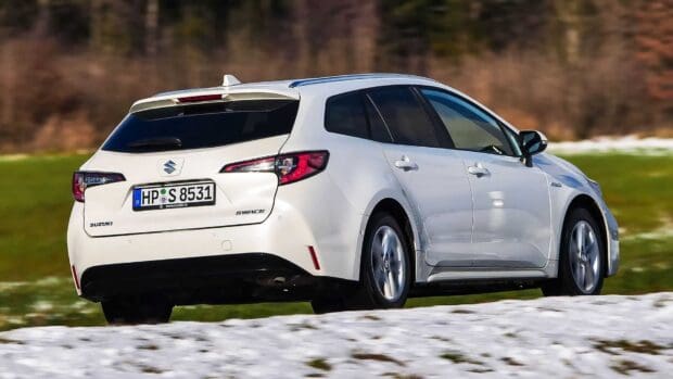 A white Suzuki Swace car is driving through a snowy and grassy field in clear weather, HD Desktop Wallpaper