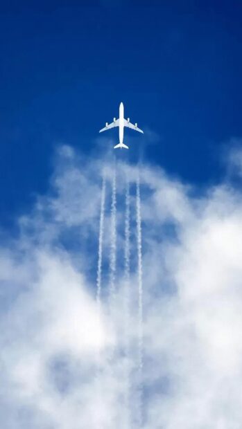 A white aircraft leaving trails above clouds in a clear blue sky, 4K Phone Wallpaper