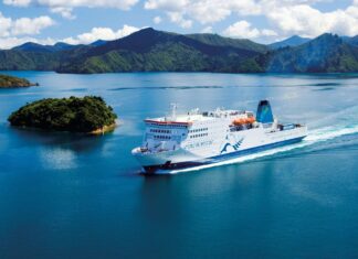 The white ferry sails through clear blue water surrounded by small green islands and mountains, HD Desktop Wallpaper