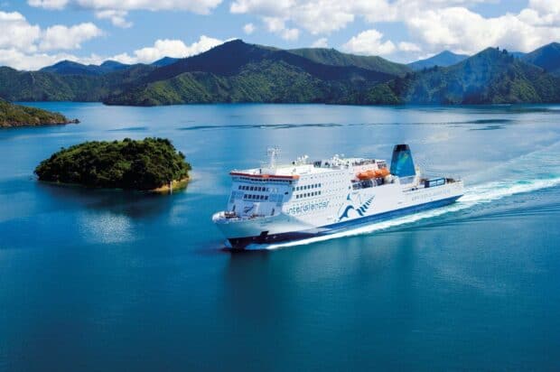The white ferry sails through clear blue water surrounded by small green islands and mountains, HD Desktop Wallpaper