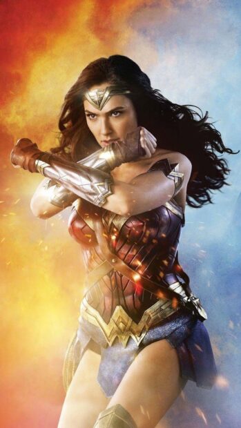 Wonder Woman is shown crossing her arms to defend herself in an intense scene, HD Phone Wallpaper