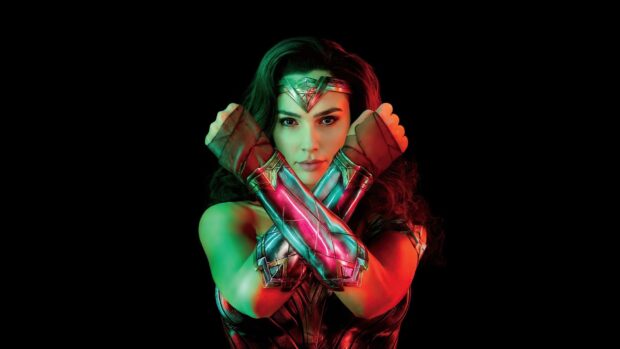 A close up of Wonder Woman crossing her arms with glowing armor, HD Desktop Wallpaper