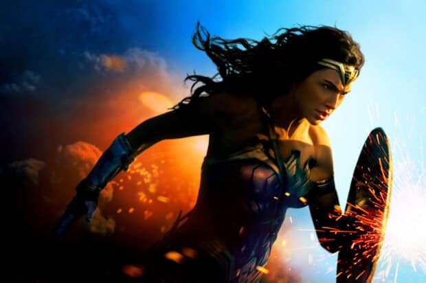 Wonder Woman movie character deflects sparks with her shield while running swiftly, 2K Desktop Wallpaper