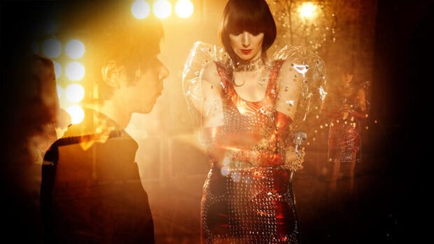 A member of the Yeah Yeah Yeahs holding a microphone during a performance, HD Desktop Wallpaper