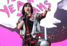 The lead singer of Yeah Yeah Yeahs points during a live stage performance, HD Desktop Wallpaper