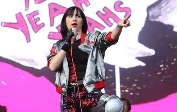 The lead singer of Yeah Yeah Yeahs points during a live stage performance, HD Desktop Wallpaper