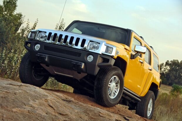 A yellow Hummer H3 is driving up rocky terrain surrounded by trees, HD Desktop Wallpaper