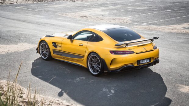 Yellow Mercedes Benz AMG GT sports car parked outdoors, 4K Desktop Wallpaper