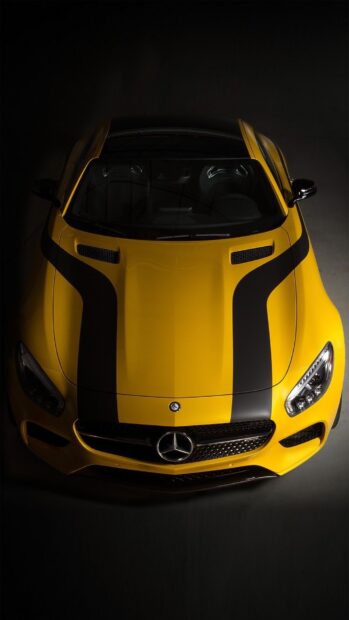 A yellow Mercedes Benz AMG GT with black racing stripes is shown from above, HD Phone Wallpaper