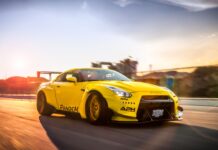 The yellow Nissan GT R is driving on a road during sunset with motion blur, 4K Desktop Wallpaper