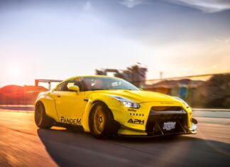 The yellow Nissan GT R is driving on a road during sunset with motion blur, 4K Desktop Wallpaper
