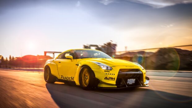 The yellow Nissan GT R is driving on a road during sunset with motion blur, 4K Desktop Wallpaper