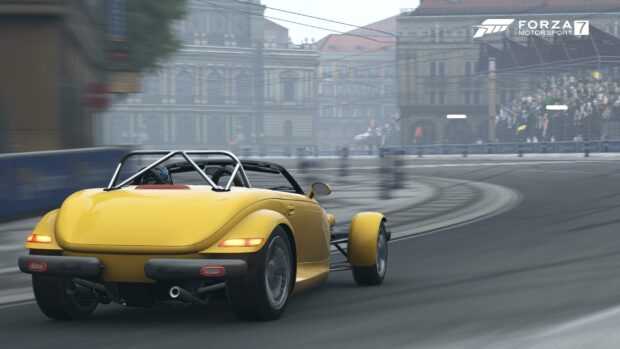 A yellow Plymouth Prowler is driving on an urban road with historic buildings in the background, HD Desktop Wallpaper