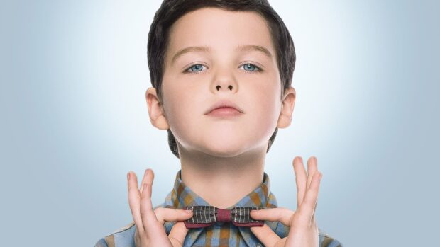 A young boy from Young Sheldon Tv Series Wallpapers fixes his bow tie with a confident look, HD Desktop Wallpaper