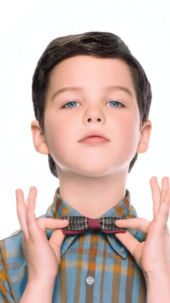 Young Sheldon wearing a checkered shirt adjusting his bow tie in a close up portrait, 4K Mobile Wallpaper