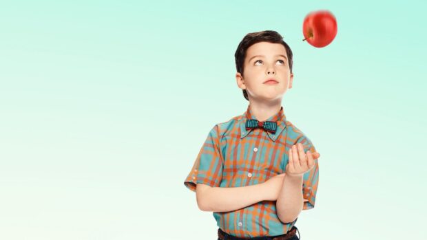 A young boy from Young Sheldon tv series looks at a floating red apple with curiosity, HD Desktop Wallpaper