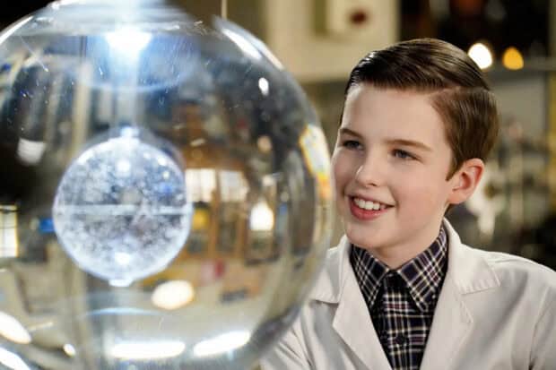 A young boy from Young Sheldon tv series examines a scientific device with a smile, HD Desktop Wallpaper