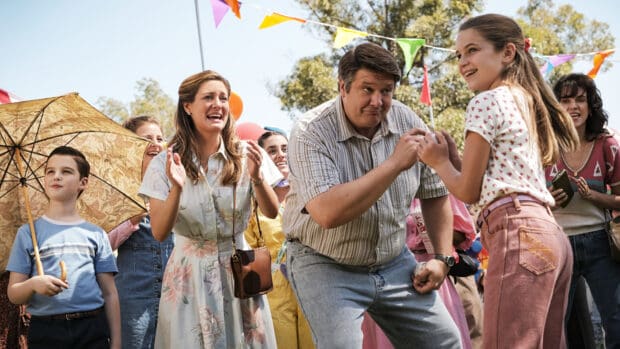 A joyful family scene from Young Sheldon tv series with a father and children at a celebration, HD Desktop Wallpaper