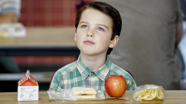 Young Sheldon Tv Series Wallpapers shows a boy sitting at a table with lunch items, HD Desktop Wallpaper
