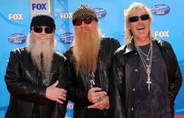 The ZZ Top band members stand together wearing sunglasses and leather jackets at an event, 2K Desktop Wallpaper