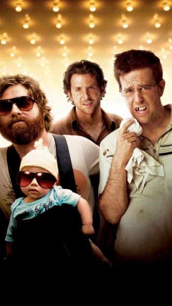 Zach Galifianakis stands with two men and a baby under glowing lights, 2K Phone Wallpaper