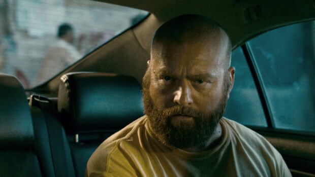 Zach Galifianakis shows a serious expression while sitting inside a car, HD Desktop Wallpaper