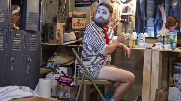 Zach Galifianakis sitting in a dressing room with face paint and a striped shirt, 2K Desktop Wallpaper
