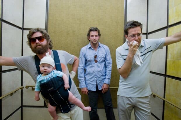 Zach Galifianakis with two men and a baby in an elevator scene, HD Desktop Wallpaper