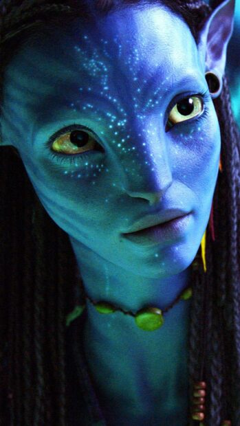 A close up of Zoe Saldana Avatar Wallpapers character Neytiri showing detailed facial features and glowing markings, 2K Mobile Wallpaper
