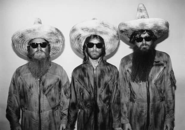 Three men from Zz Top wearing large hats and sunglasses pose in black and white, 2K Desktop Wallpaper