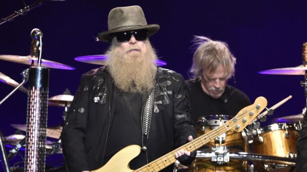 A musician from Zz Top playing bass guitar during a live concert, HD Desktop Wallpaper