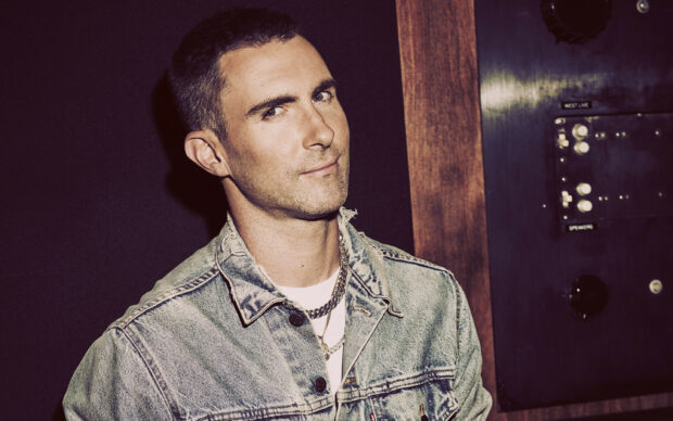 Adam Levine wearing a denim jacket and chains with a confident look, 2K Desktop Wallpaper