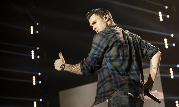 Adam Levine performing on stage with a thumbs up gesture during a concert, HD Desktop Wallpaper