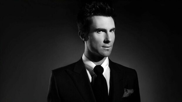 Adam Levine is wearing a suit and tie in this black and white portrait, HD Desktop Wallpaper