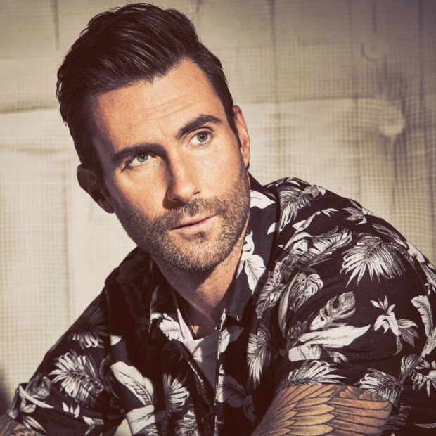 Adam Levine Wallpapers shows a close up of a man with a beard wearing a floral shirt looking thoughtfully, HD Mobile Wallpaper
