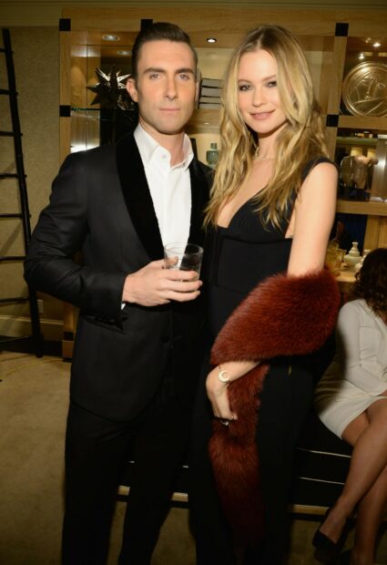 Adam Levine with a woman dressed elegantly at a social gathering, HD Phone Wallpaper