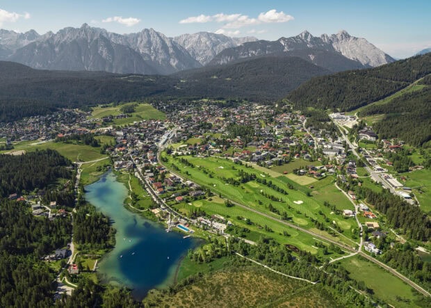 Aerial view of an Austrian town surrounded by mountains and a lake featuring Austria wallpapers, HD Desktop Wallpaper