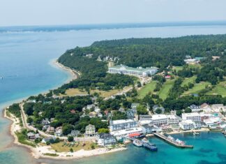 The aerial view captures Mackinac Island harbor surrounded by greenery and buildings, HD Desktop Wallpaper