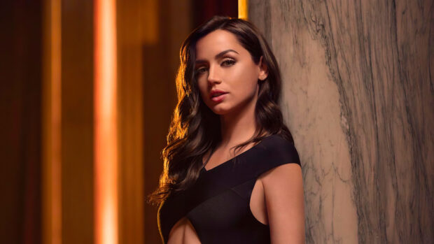 Ana De Armas looks stunning in a black outfit leaning against a marble wall, 4K Desktop Wallpaper