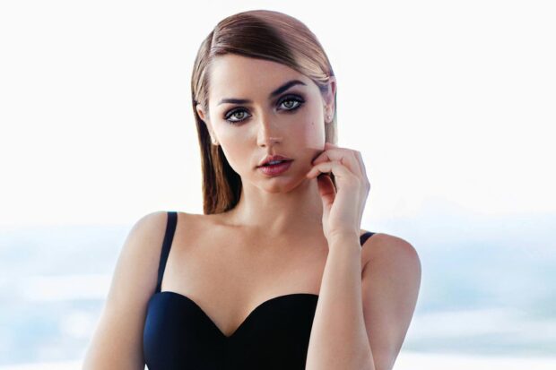 Ana De Armas looks directly at the camera in a black dress with a soft background, 2K Desktop Wallpaper