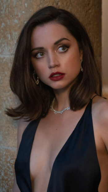 Ana De Armas wears a black dress and jewelry while looking to the side, 4K Phone Wallpaper