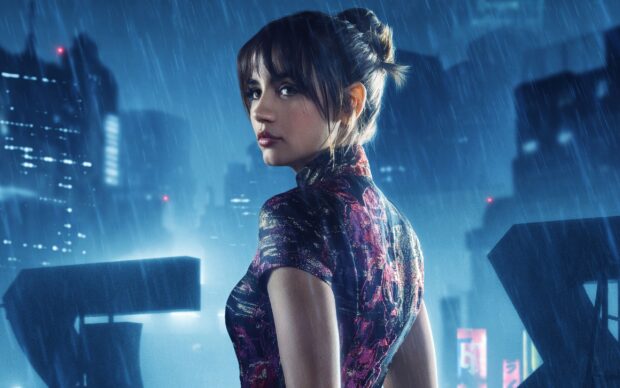 Ana De Armas stands in the rain against a glowing cityscape backdrop, 2K Desktop Wallpaper