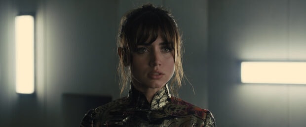 Ana De Armas looks serious wearing a patterned outfit in a dimly lit room, 2K Desktop Wallpaper