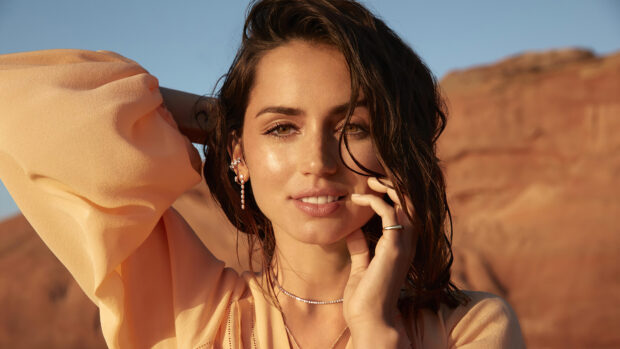 A close up of Ana De Armas posing outdoors with warm tones and jewelry, 4K Desktop Wallpaper