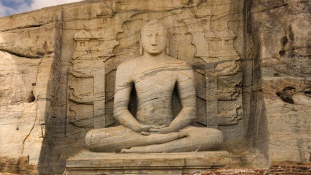 A detailed view of an ancient Buddha statue carved into a rock in Sri Lanka depicting meditation, HD Desktop Wallpaper