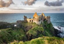 The ancient castle ruins sit on steep cliffs by the ocean in Northern Ireland Wallpapers, 2K Desktop Wallpaper