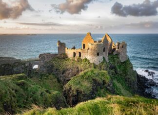 The ancient castle ruins sit on steep cliffs by the ocean in Northern Ireland Wallpapers, 2K Desktop Wallpaper