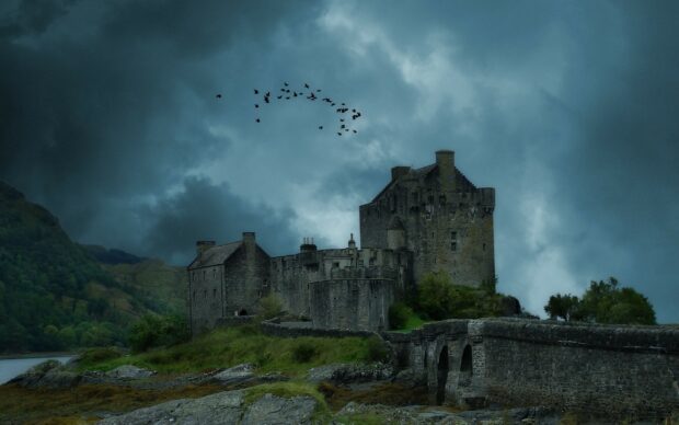 A historic stone castle stands surrounded by nature and flying birds in United Kingdom Wallpapers, 2K Desktop Wallpaper