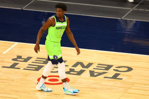 Anthony Edwards wearing Minnesota uniform walking on basketball court