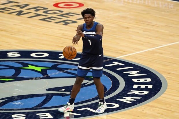 Anthony Edwards preparing to pass the basketball on a Timberwolves court